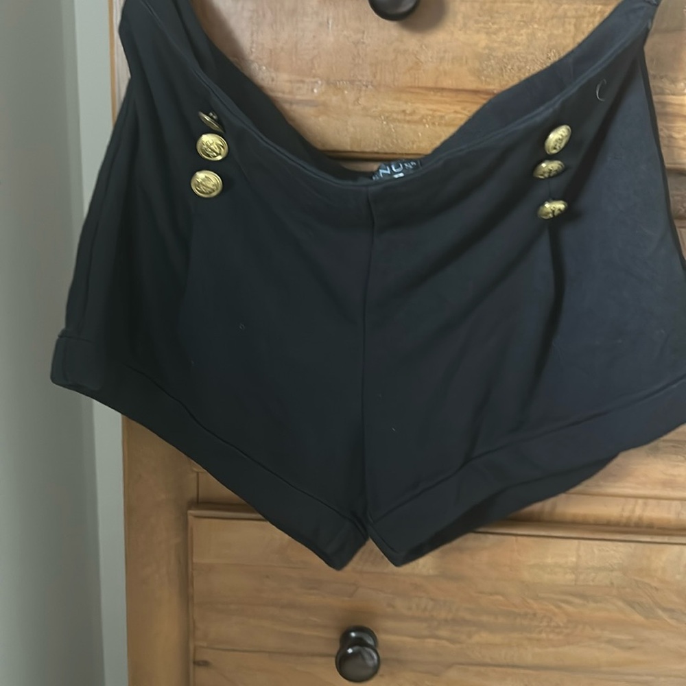 Brass button, side. Zip cuffed short black